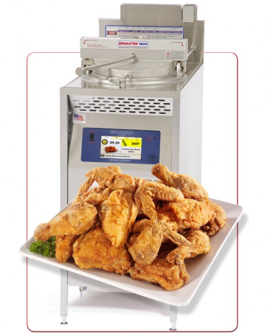 Broaster machine with Chicken on white plate with lettuce